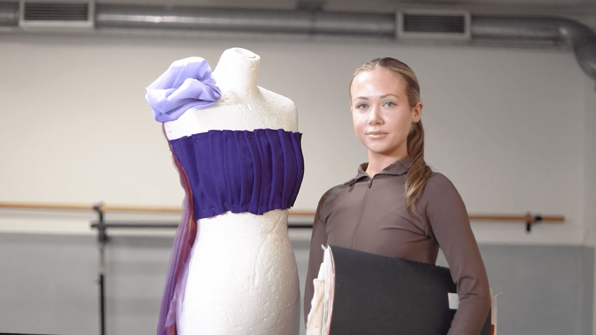 A young person next to a manequinn