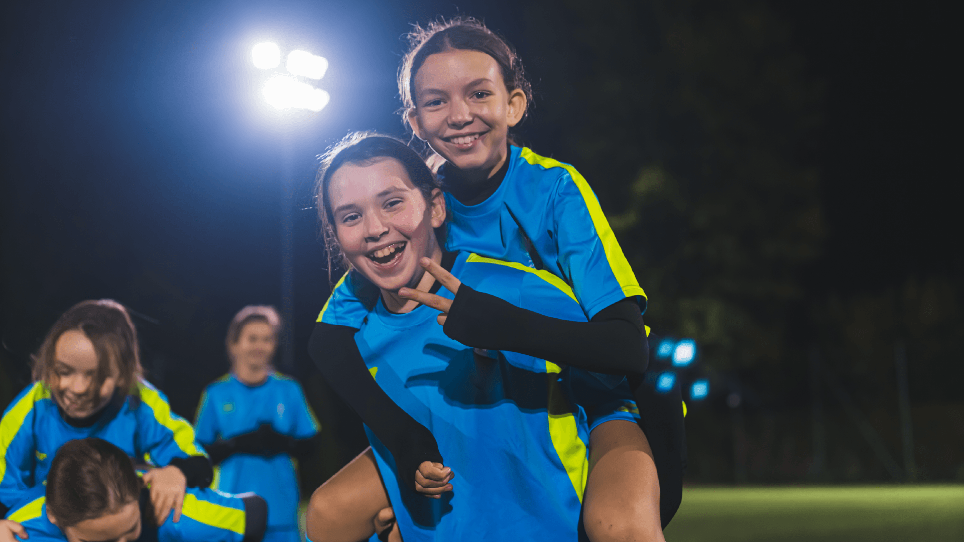 Young people celebrating a football match