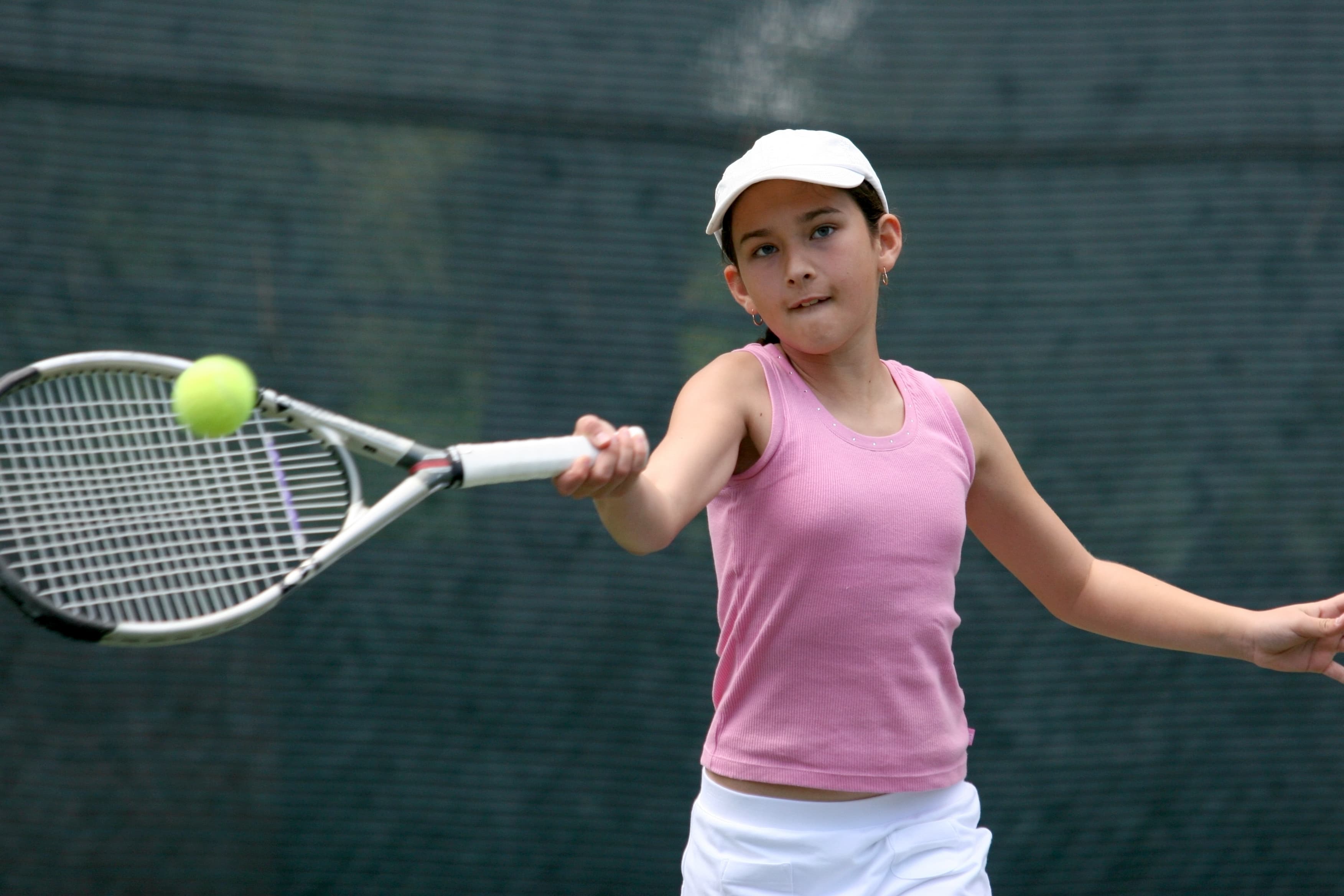 A young person playing tennis